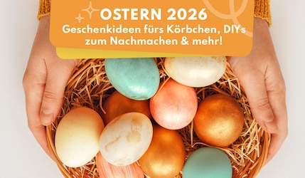 Frau hält mit bunten Eiern gefüllten Osterkorb fest