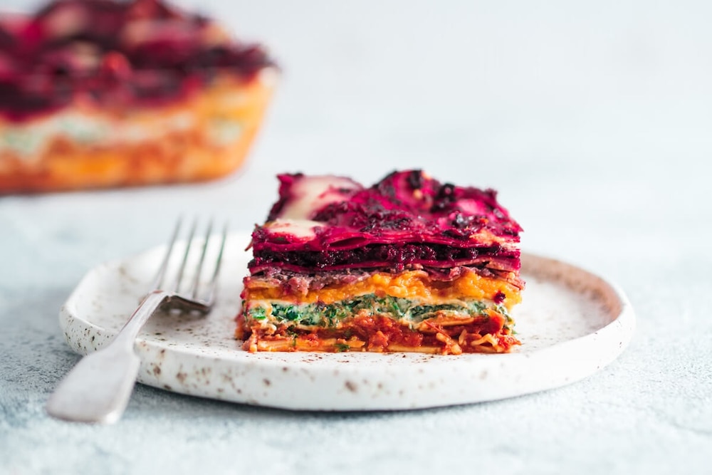 Regenbogen-Lasagne auf weißem Teller